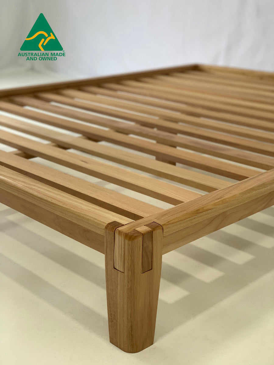 Side profile of Castle Joint bed frame in Blackbutt wood finish
