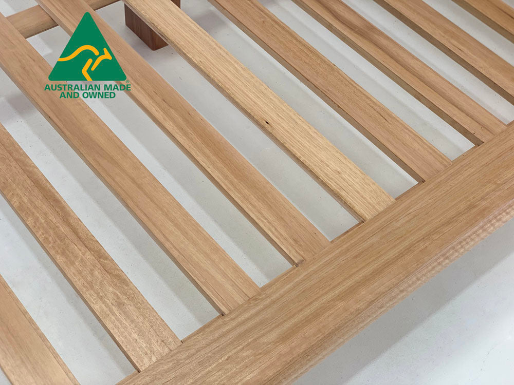 Chunk hardwood bed frame styled in contemporary master bedroom