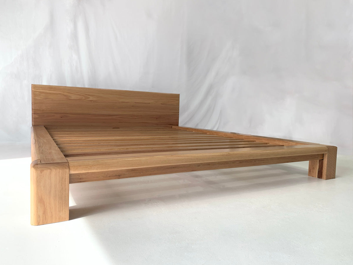 Chunk wooden bed frame with minimalist low-profile style